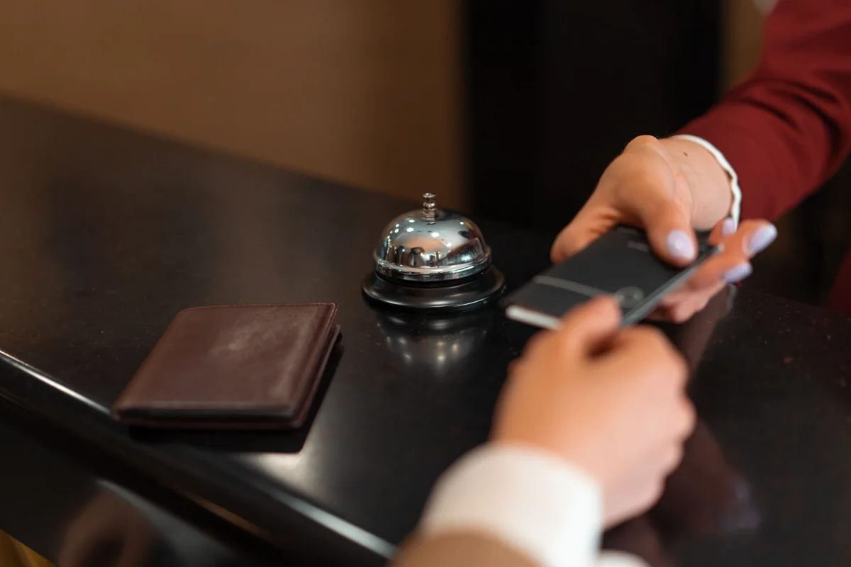 Smartphone und Gästekarte am Hotelempfang